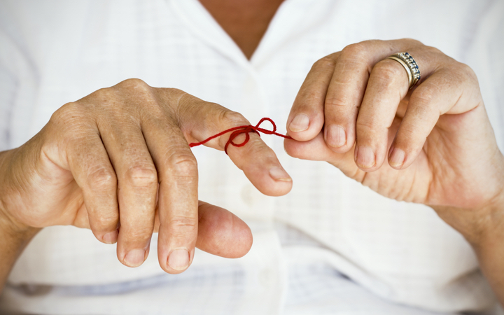 Reminder string tied around a finger