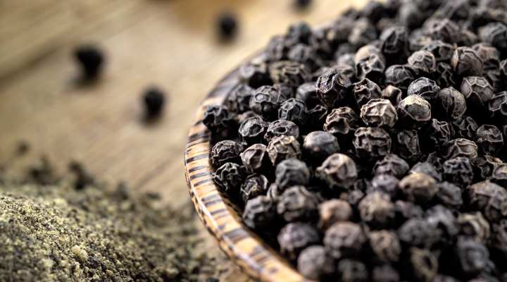 Whole and ground black peppercorns