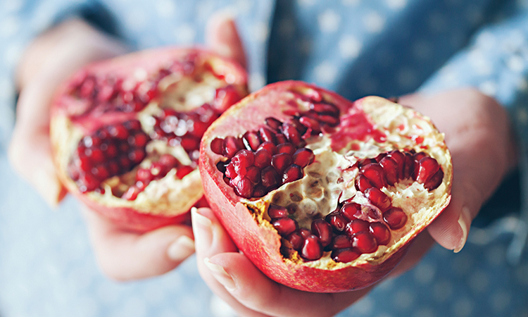 Person holding pomegranate