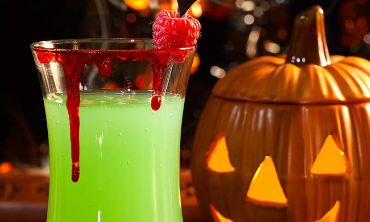 Halloween cocktail in front of pumpkin